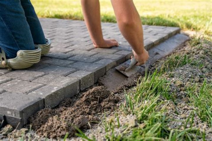 Do you put sand under pavers?